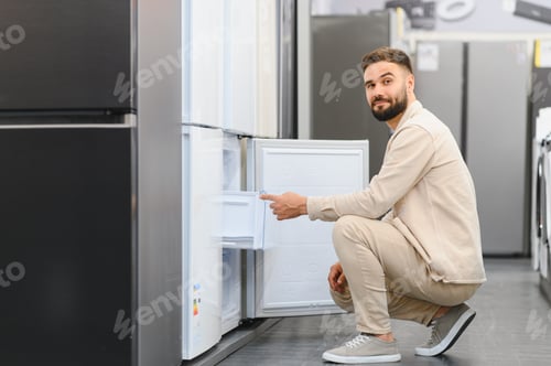 Preview: Customer choosing new refrigerator in electronics store
