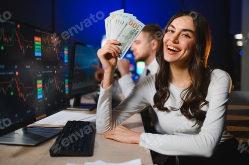 Preview: Woman holding dollar bills celebrating trading success