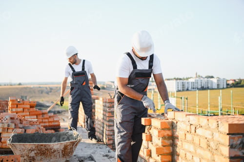 Preview: Indian construction workers work on the construction of a brick house. Construction of a brick wall