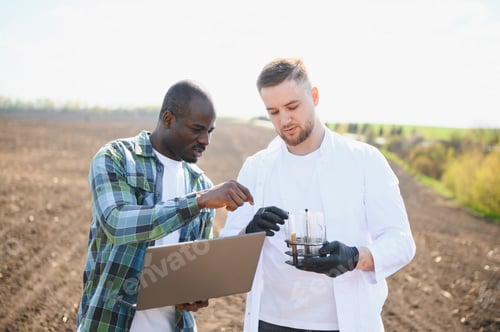Preview: Agronomist and farmer analyzing soil samples in field
