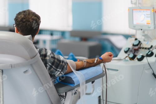 Preview: Young man donating plasma at medical clinic