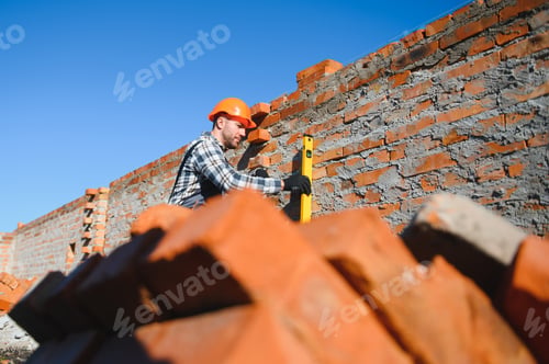 Preview: Portrait of a builder in the process of working on a construction site outdoors
