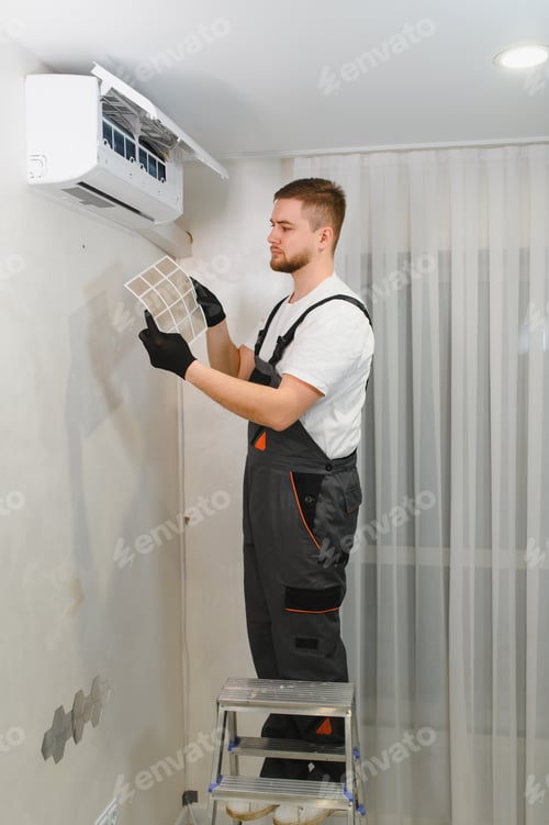 Preview: Technician servicing air conditioner removing dirty filter
