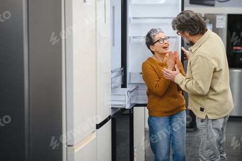 Preview: Senior couple excitedly shopping for new refrigerator in appliance store