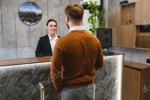 Preview: Guest checking in at modern hotel reception desk