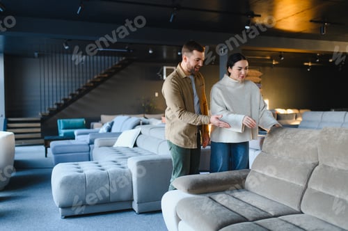Preview: Couple shopping for sofa in furniture store