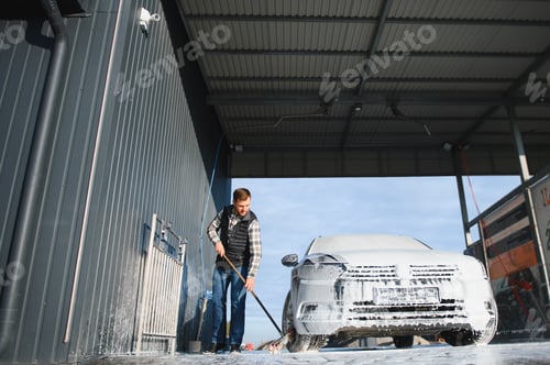Preview: Car is washed at a professional car wash. Man washes a car with foam. Detailing