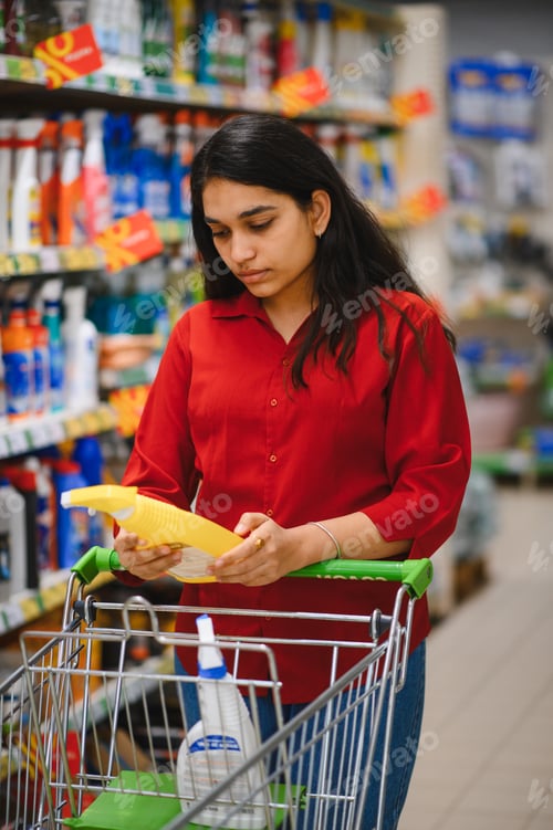 Preview: Woman shopping for household cleaning supplies in supermarket