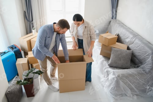 Preview: Couple packing belongings into cardboard boxes for moving