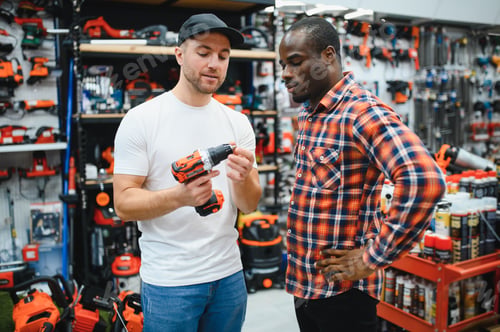Preview: The seller helps the buyer choose a screwdriver in a hardware store.
