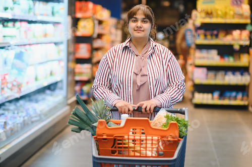 Preview: Indian woman pushing shopping cart in grocery store