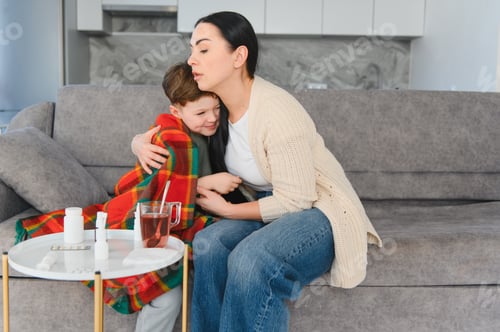 Preview: Mother embracing sick child feeling unwell at home