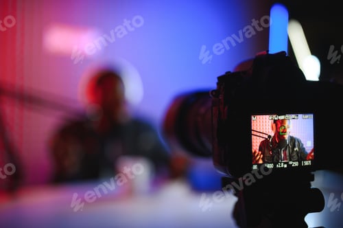 Preview: Male lifestyle vlogger recording live podcast vlog on camera