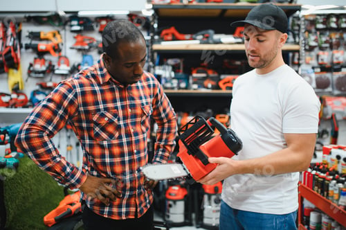 Preview: A sales consultant helps a client choose an electric saw in a hardware store