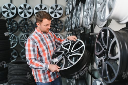 Preview: Male Customer Choosing Alloy Wheel Rims at Car Repair Service or Auto Store