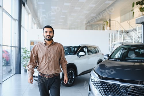 Preview: Man smiling in car dealership showroom
