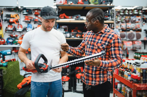 Preview: The sales consultant helps the client chooses a brushcutter in a hardware store