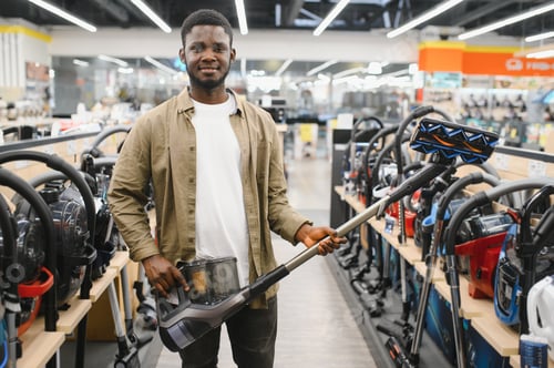 Preview: New vacuum cleaner. An African man buys a vacuum cleaner in a household goods store