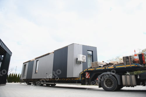 Preview: Modular home being transported on flatbed truck
