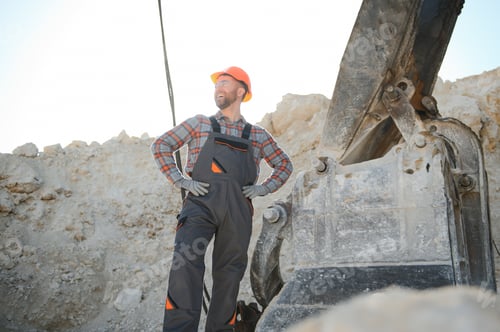 Preview: Portrait of a worker standing on the background of a stone quarry