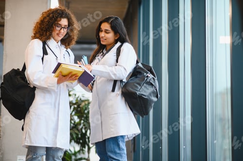 Preview: Medical students discussing coursework wearing lab coats