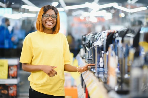 Preview: Smart modern african american female customer choosing coffee machine at electronics store