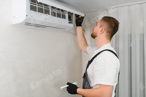 Preview: Technician maintaining air conditioner with open cover