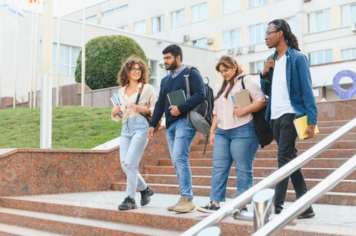 Preview: Diverse students walking down university campus stairs