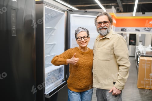 Preview: Senior couple buying new refrigerator in appliance store