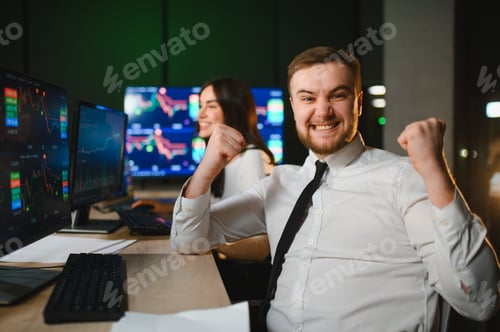 Preview: Happy stock trader celebrating market success at terminal