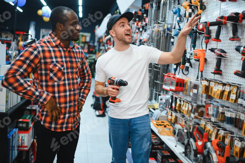 Preview: Buying a drill or screwdriver. A consultant in a hardware store advises a male customer on the purch