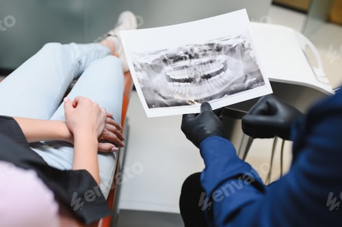 Preview: Dentist discussing dental x ray with patient