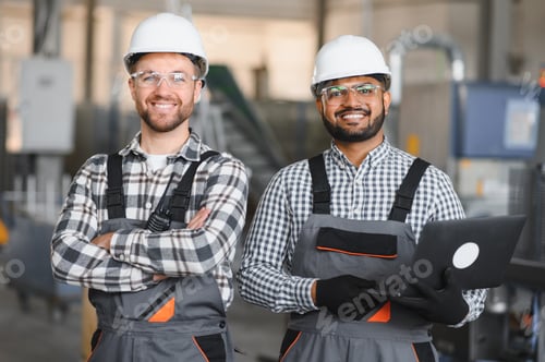 Preview: Two male international workers in overalls work together at a machine for the production of aluminum