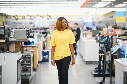 Preview: Young African American Woman Shopping for Appliance in Supermarket