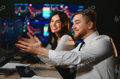 Preview: Financial traders analyzing charts, celebrating market success