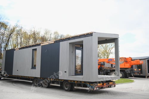 Preview: Modular prefab home unit transporting on flatbed trailer
