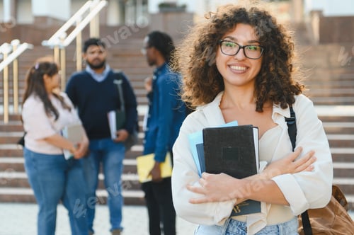 Preview: Happy university student smiling on campus