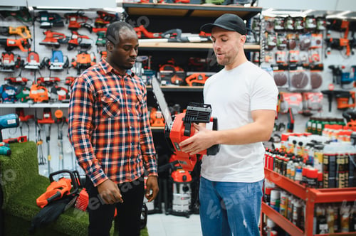 Preview: A sales consultant helps a client choose an electric saw in a hardware store