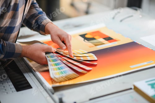 Preview: Print worker checking color swatches at factory press