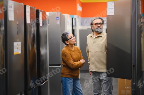 Preview: Mature couple shopping for new refrigerator in appliance store