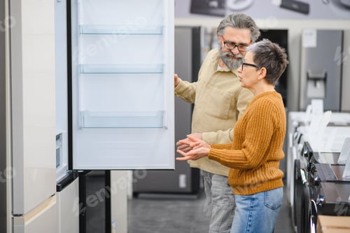 Preview: Senior couple buying new refrigerator in appliance store