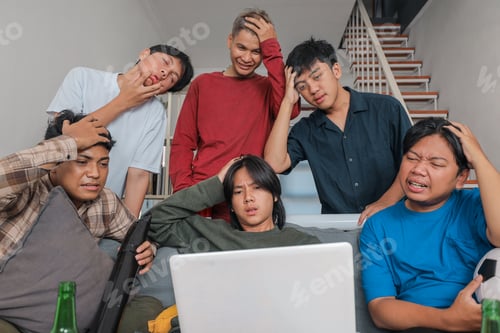 Preview: Indonesian Men Looking Disappointed and Stressed While Watching Soccer Match Online on Laptop