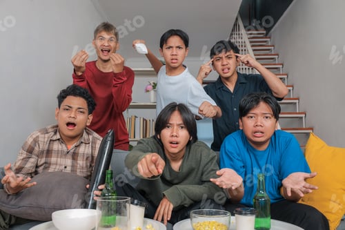Preview: Group of Young Asian Men Looking Disappointed and Frustrated while Watching Sports Match Together