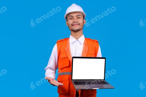 Preview: Asian Male Engineer in Safety Vest and Hard Hat Holding Laptop with Blank White Screen