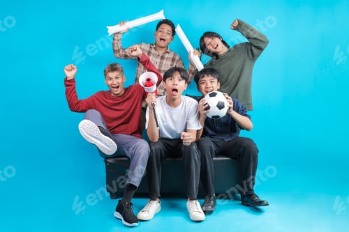 Preview: Group of Young Indonesian Men Cheering and Celebrating Victory While Watching Football Match Togethe