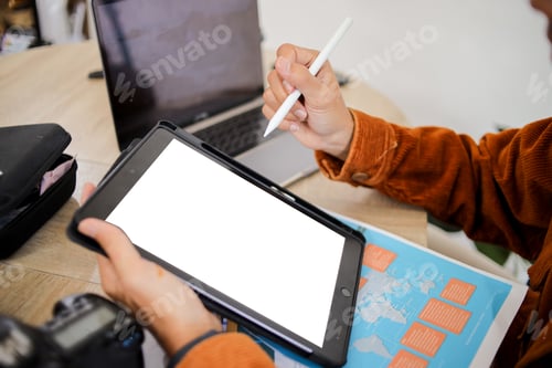 Preview: Close up of Designer Holding Tablet with Blank White Mockup Screen While Using Stylus Pen