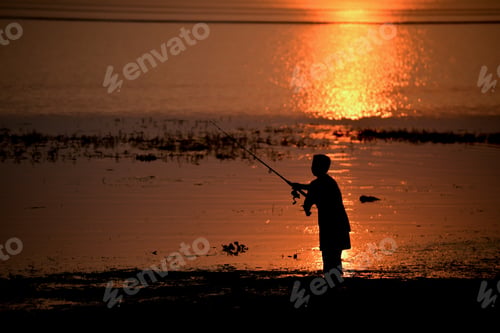 Preview: Young Boys Fishing on a Lake in Sunrise Background