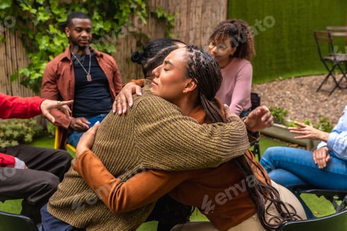Preview: Diverse group embracing during outdoor therapy session
