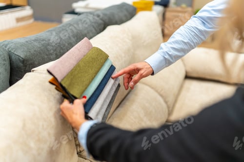 Preview: Customer choosing sofa upholstery fabric swatches in furniture store