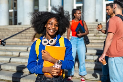 Preview: Happy african american student standing on university campus